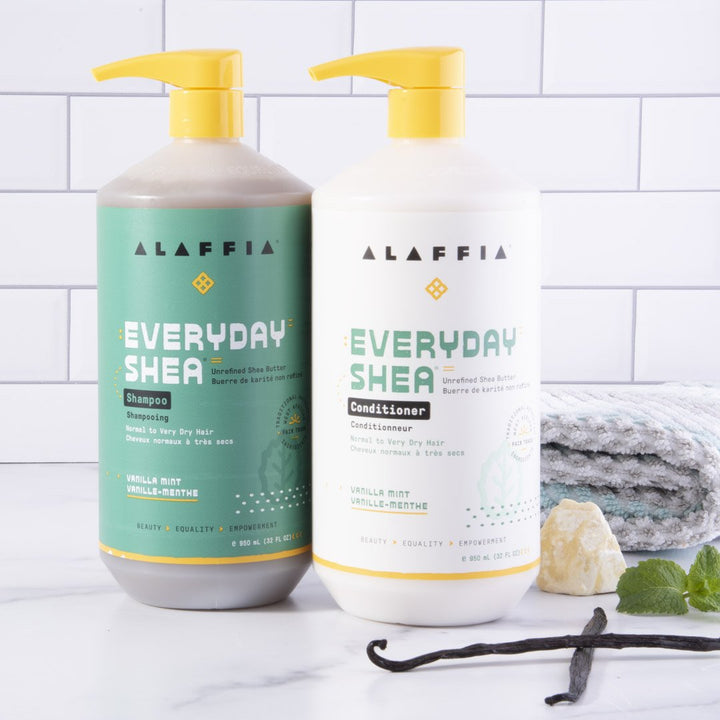 Alaffia vanilla mint shampoo and conditioner pictured with vanilla, fresh mint, and shea butter