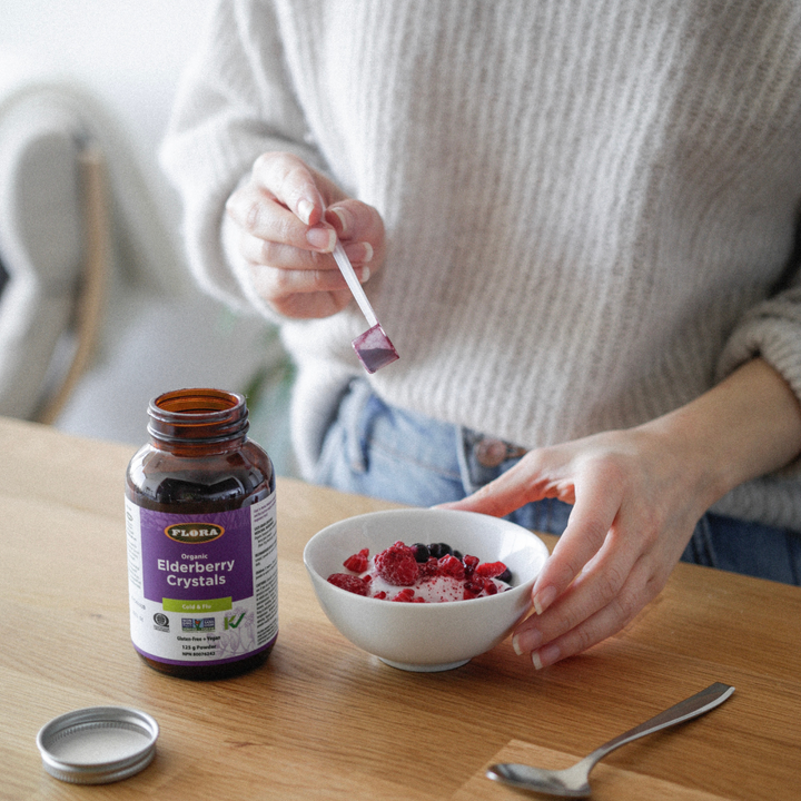 elderberry crystal powder sprinkled over healthy yogurt with fresh fruit, used to help relieve cold and flue symptoms