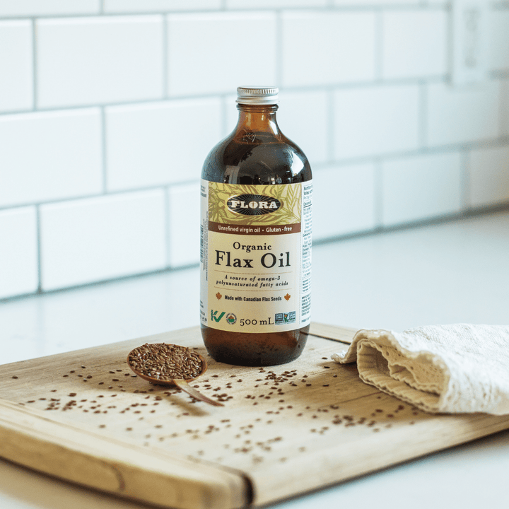 organic flaxseed oil made from Canadian flaxseeds on cutting board with flax