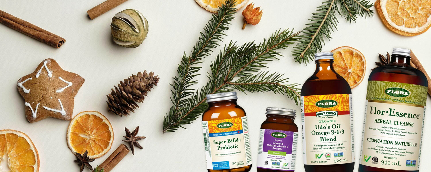 Supplement bottles with Christmas decorations on a white background