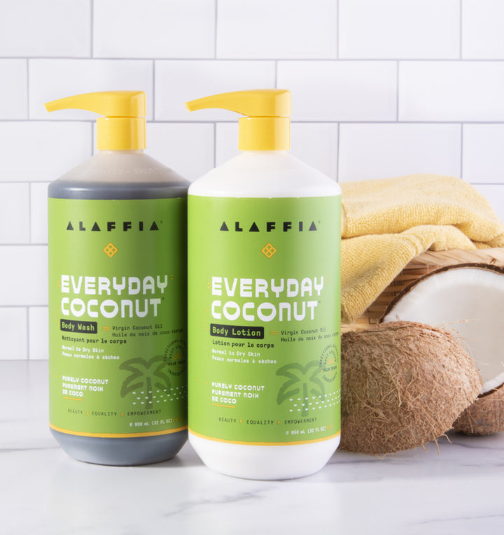 Fair trade lotion and body wash with coconut by Alaffia, pictured with coconuts and towels