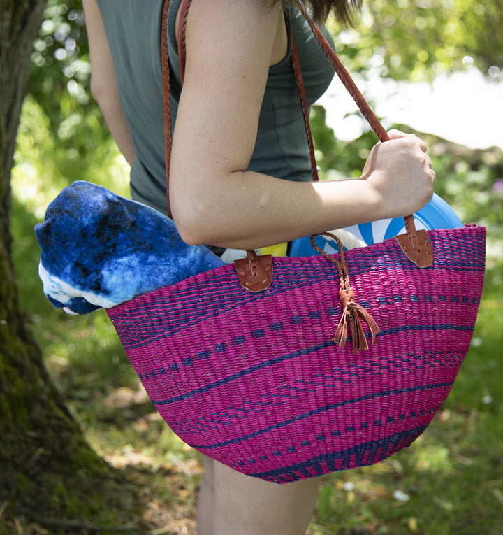 flexible hand woven shoulder bag in purple hand woven African savanna grass on shoulder